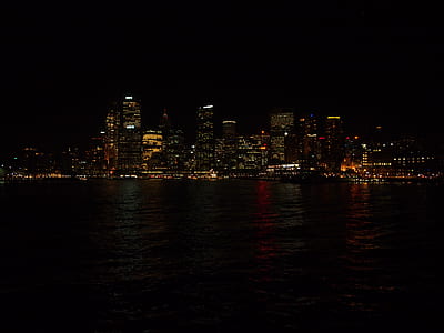 skyscrapers near body of water taken during night time thumbnail