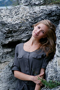 woman standing behind rock formation thumbnail