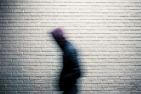 person walking with brick wall on background thumbnail