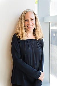 Woman Wearing Black Long-sleeved Shirt Leaning on Wall thumbnail