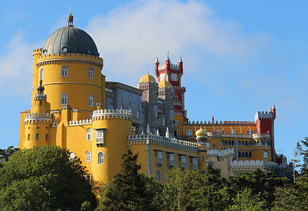 yellow and red castle under blue and white sky thumbnail