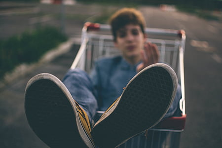 selective focus photography of man sitting on gray shopping card thumbnail