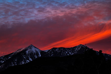 snow-covered mountains during sunset thumbnail