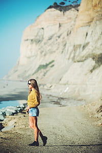 woman standing on gray concrete ground during daytime thumbnail