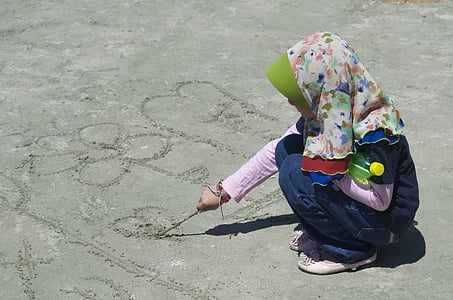 person drawing on sand thumbnail