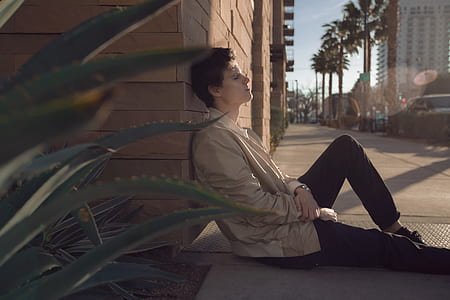 man sitting on the street duting day time thumbnail