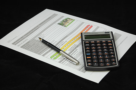 black and gray desk calculator with pen thumbnail