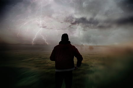man standing under cloudy sky thumbnail