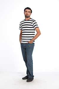 man in black and white striped t-shirt with hands on pocket standing on white floor thumbnail