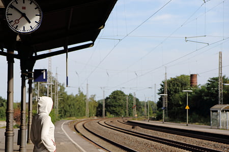 person standing on train station thumbnail