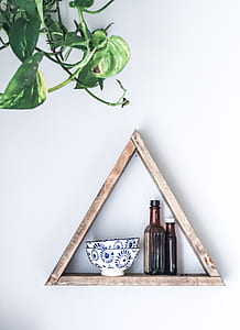 photo of brown wooden pyramid wall mounted shelf with bowls and bottles thumbnail