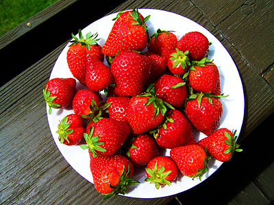 plate of strawberries on wooden surface thumbnail
