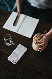 person holding clear glass with cream liquid thumbnail
