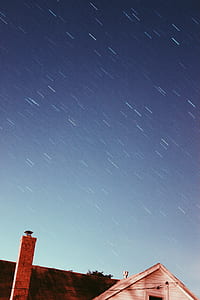 time lapse photography of house under starry sky thumbnail