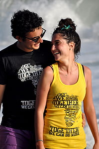 woman wearing yellow printed tank top and man wearing black printed t-shirt thumbnail