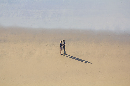 man and woman standing on desert during daytime thumbnail