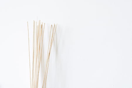 sticks near white wall thumbnail