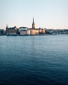 gray building near body of water thumbnail