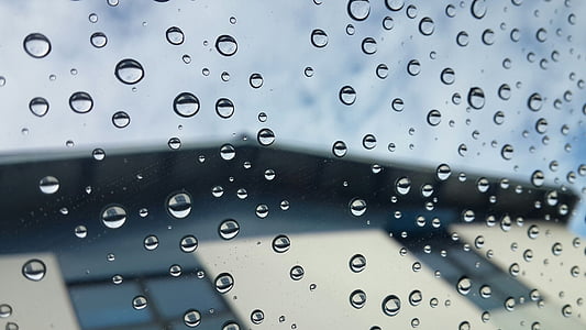 selective focus photography of water droplets on clear glass sheet thumbnail