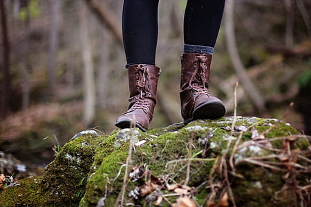 person wearing brown leather hiking boots stepping on the stone thumbnail