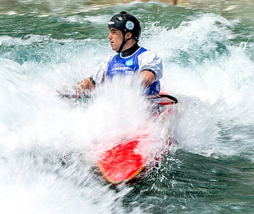 man riding in red and yellow kayak thumbnail