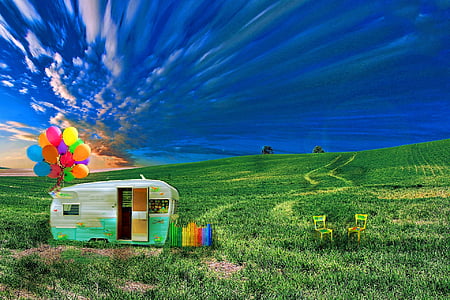 white and green horse trailer with air balloons surrounded by green brass during daytime thumbnail