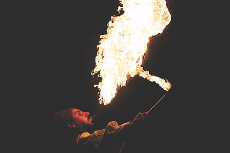 man holding black stick while doing fire breathing thumbnail