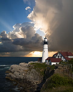 photo of white lighthouse near body of water thumbnail
