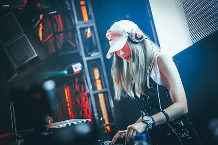 woman wearing headphones using DJ mixer thumbnail