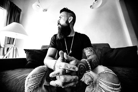 grayscale photography of man sitting on chair thumbnail