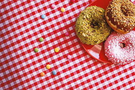 close-up photo of doughnuts on red ceramic plate thumbnail