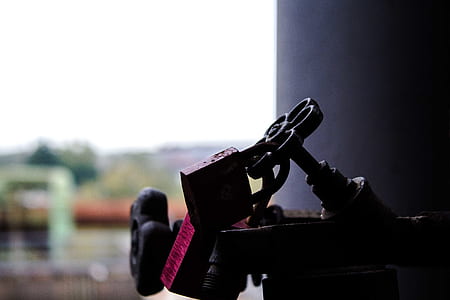 close-up photo of brown metal pipe knob with padlocks thumbnail
