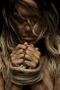 woman with brown rope on her hand thumbnail