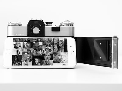 black and white photography of turned on iPhone beside camera thumbnail