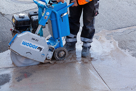 man operating blue and gray Weber SM82 concrete saw thumbnail