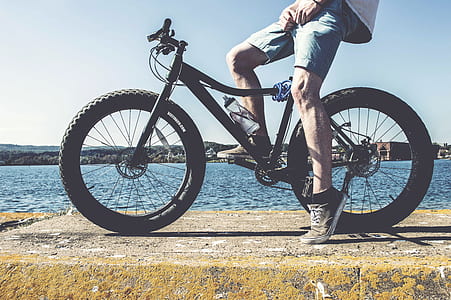 person riding black bicycle thumbnail