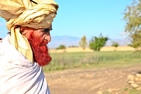 man in brown turban and white shirt thumbnail