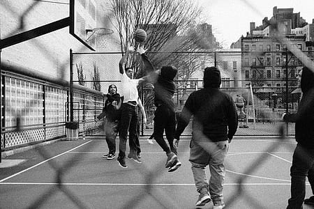 grayscale photography of people playing basketball outdoor thumbnail