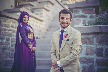 man wearing gray suit and woman wearing purple abaya wedding dress thumbnail