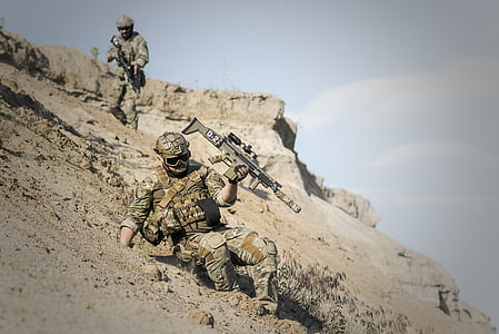 soldier in realistic camouflage suit holding assault rifle sliding downhill thumbnail
