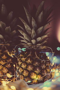 black sunglasses with silver frame on pineapple fruit thumbnail