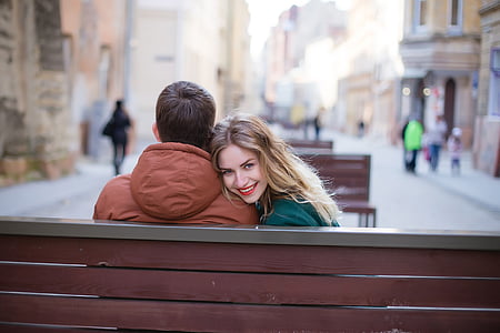 woman smiling beside the man wearing brown hooded jacket thumbnail