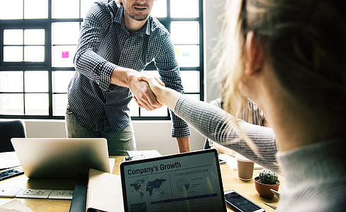 man shaking hands of sitting woman thumbnail