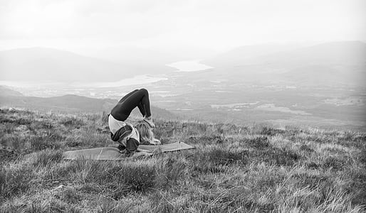 grayscale photo of woman on yoga mat thumbnail