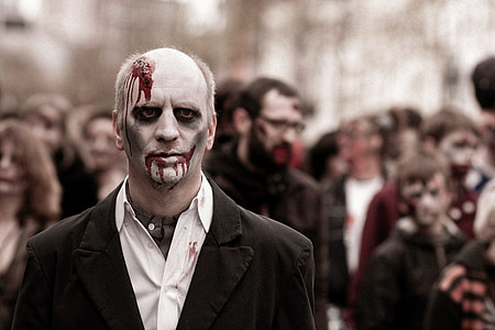selective focus photography of men in black peak lapel suit jacket with halloween make up thumbnail