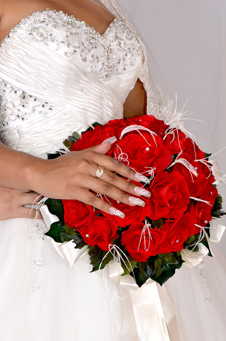 woman holding red rose bouquet