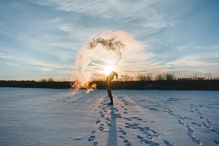 person whipping snow during golden hour thumbnail