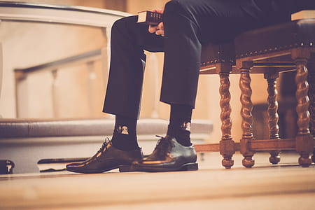 Person Sitting On A Chair Holding Book thumbnail