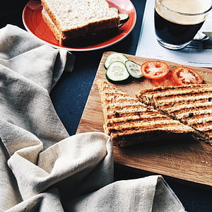 toasted bread, cucumber and tomatoes on chopping board thumbnail