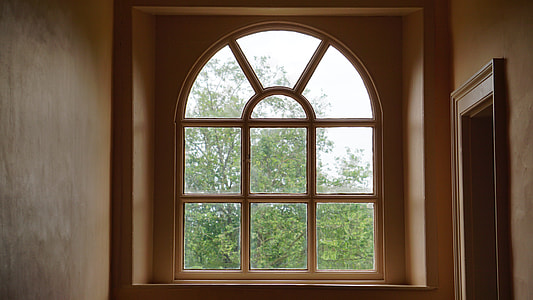 brown wooden framed arch window at daytime thumbnail